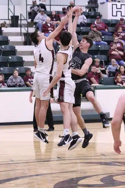 Izard County Consolidated's Caleb Faulkner reaches high during the 1A State Tournament