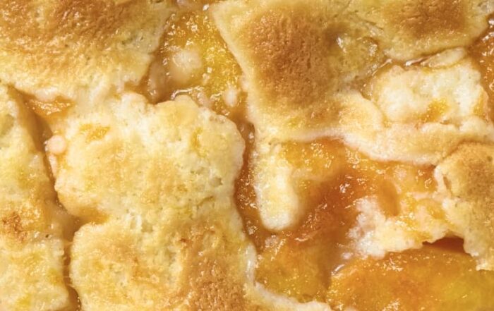 Close-up of golden brown peach cobbler.